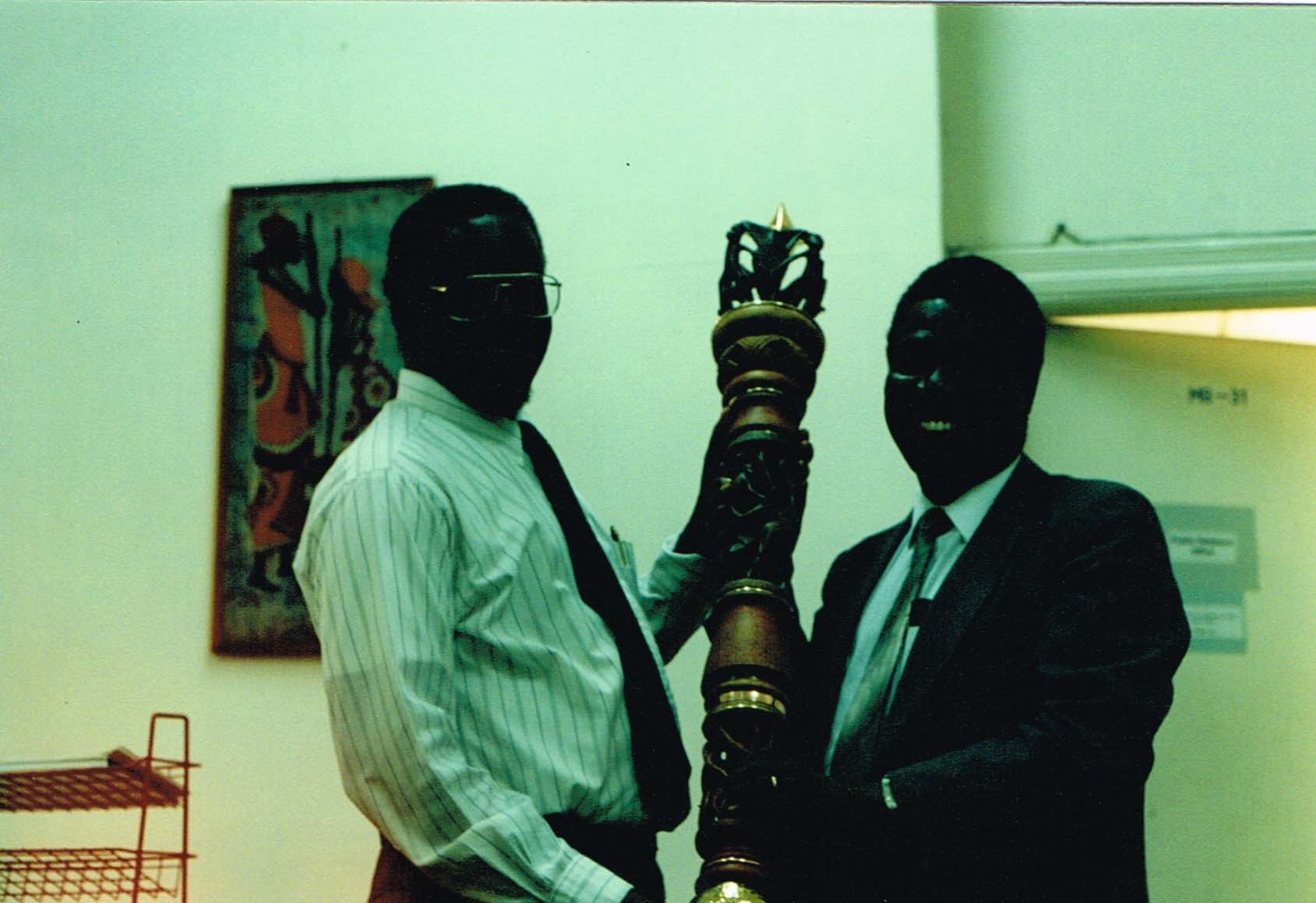 Prof Talitwala (left) and Prof Godfrey Nguru (right) the then DVC Academic Affairs, display the mace after Daystar Univesity College was awarded charter to become Daystar University in1994